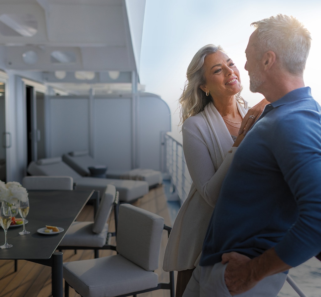 a couple embracing on their suite veranda