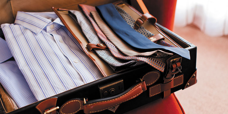 open suite case with neatly folded clothes