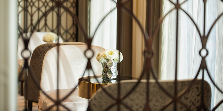 elegant room aboard regent seven seas cruises with chairs and tables adorned with fresh flowers