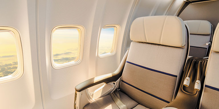 free airfare in business class airplane seat with window view