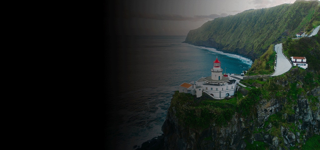 Lighthouse on cliffside in São Miguel, Azores overlooking the Atlantic Ocean