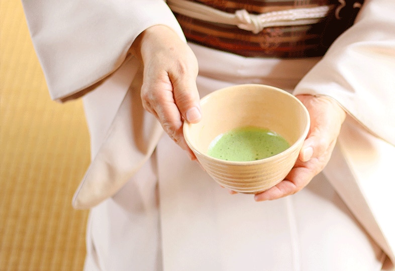 Geisha holding a cup of tea
