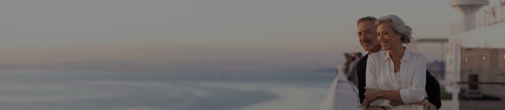 couple looking out at the sea aboard a Regent cruise ship