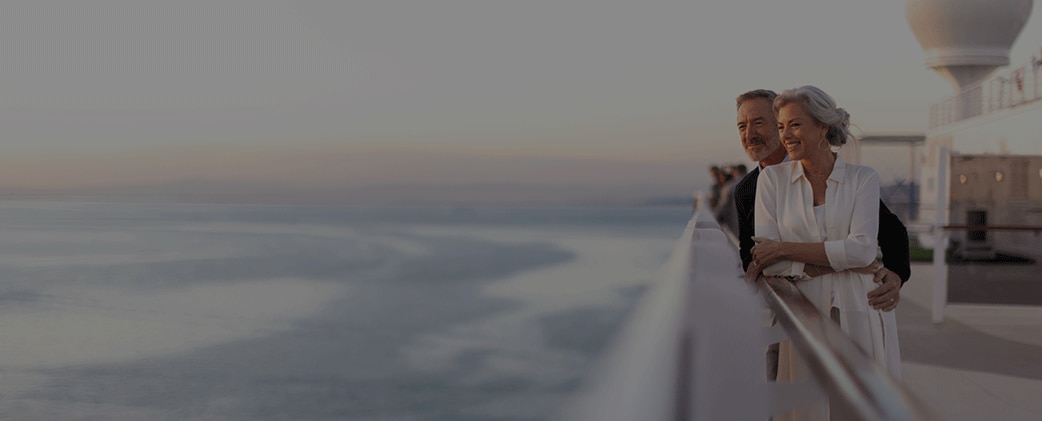 couple looking out at the sea aboard a Regent cruise ship