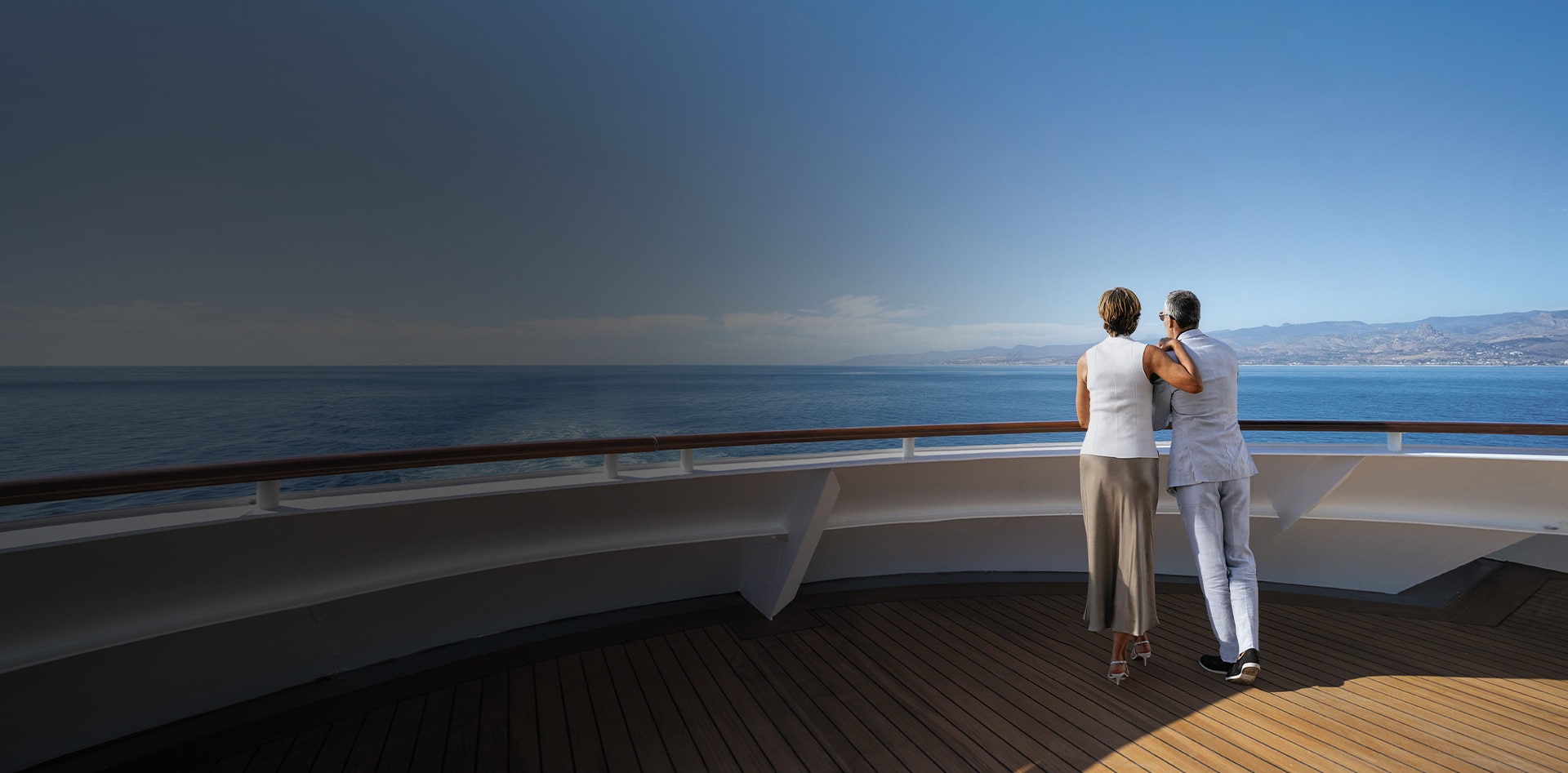 Couple enjoying the views from a Regent luxury cruise ship