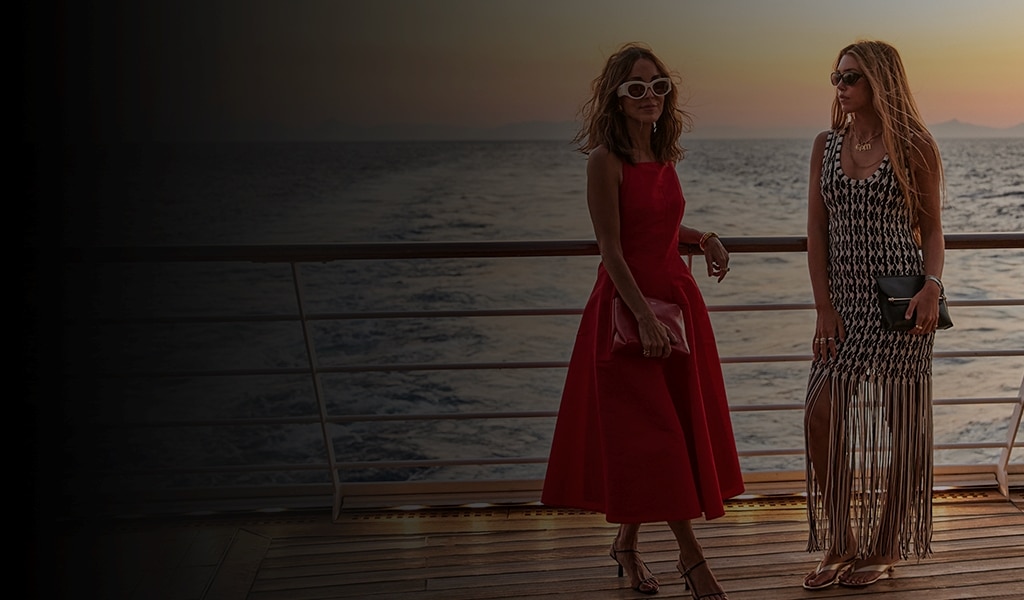 friends enjoying the sunset views from The World's Most Luxurious Fleet
