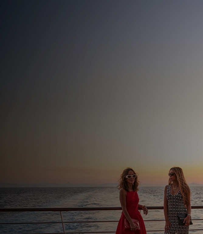 friends enjoying the sunset views from The World's Most Luxurious Fleet