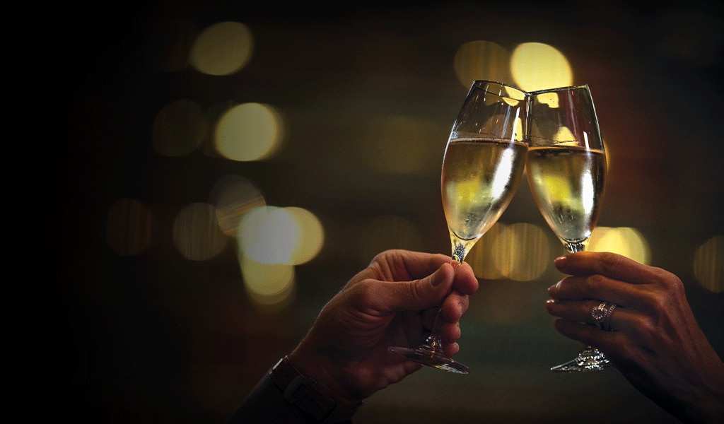 Two champagne glasses being clinked