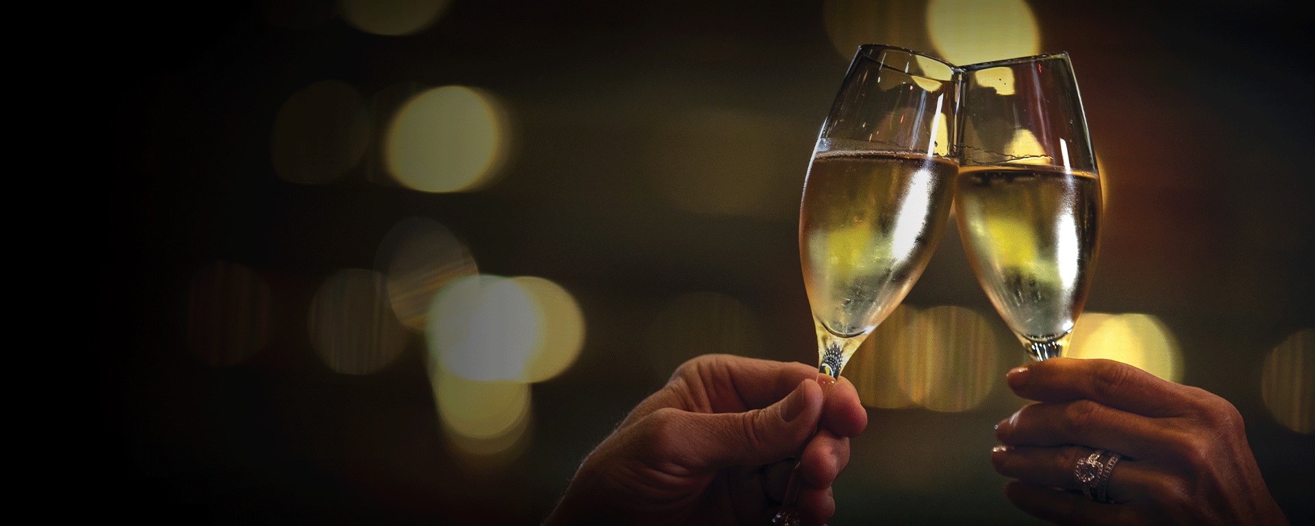 Two champagne glasses being clinked