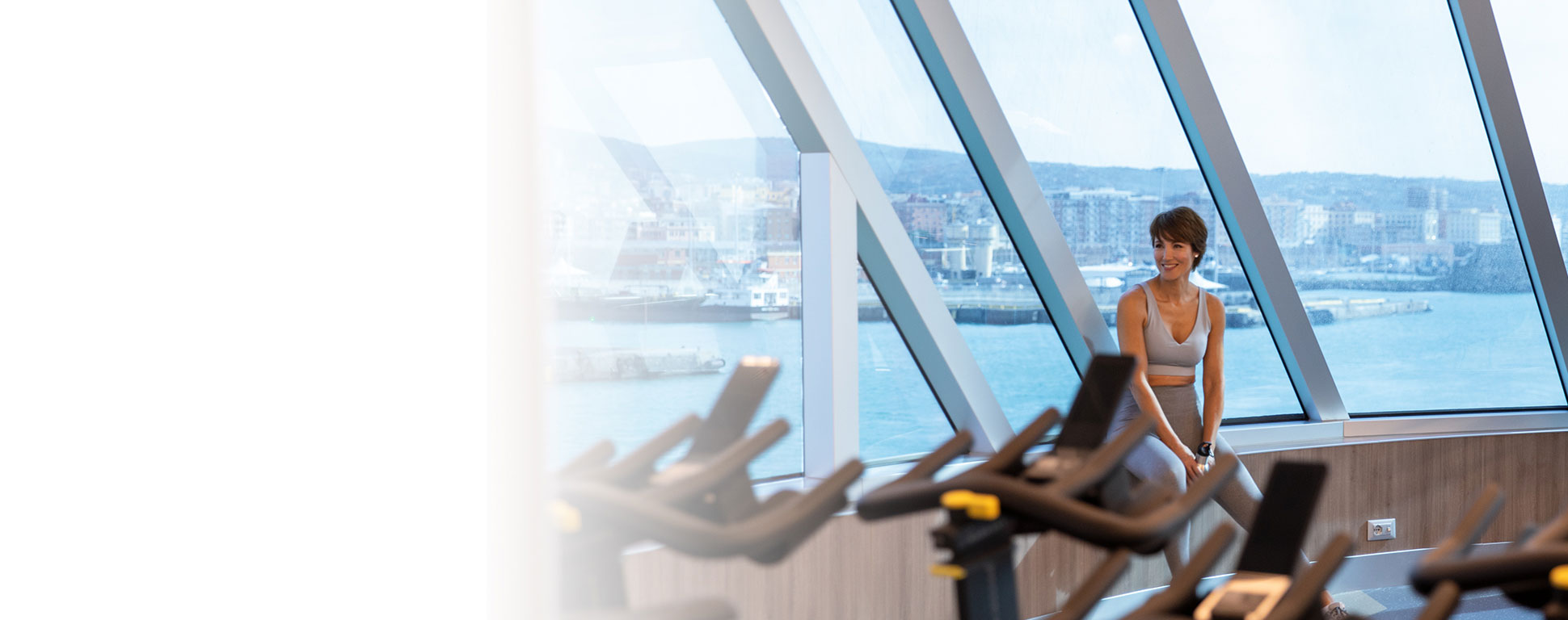 a woman in workout clothes at the fitness center on board Seven Seas Splendor