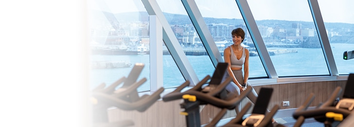 a woman in workout clothes at the fitness center on board Seven Seas Splendor
