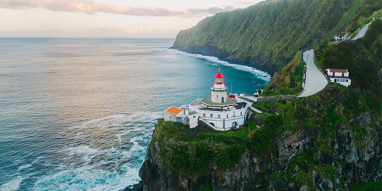 Lighthouse on cliffside in São Miguel, Azores overlooking the Atlantic Ocean