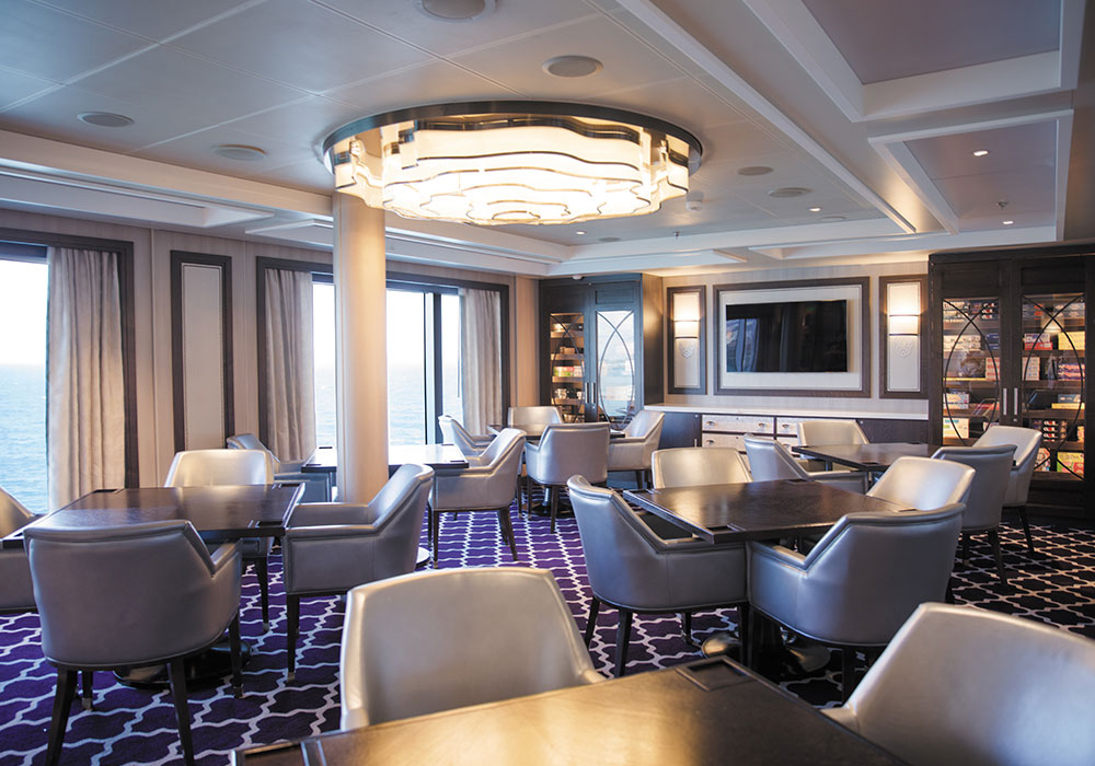 el salón de juegos a bordo del Seven Seas Splendor con asientos de cuero y juegos